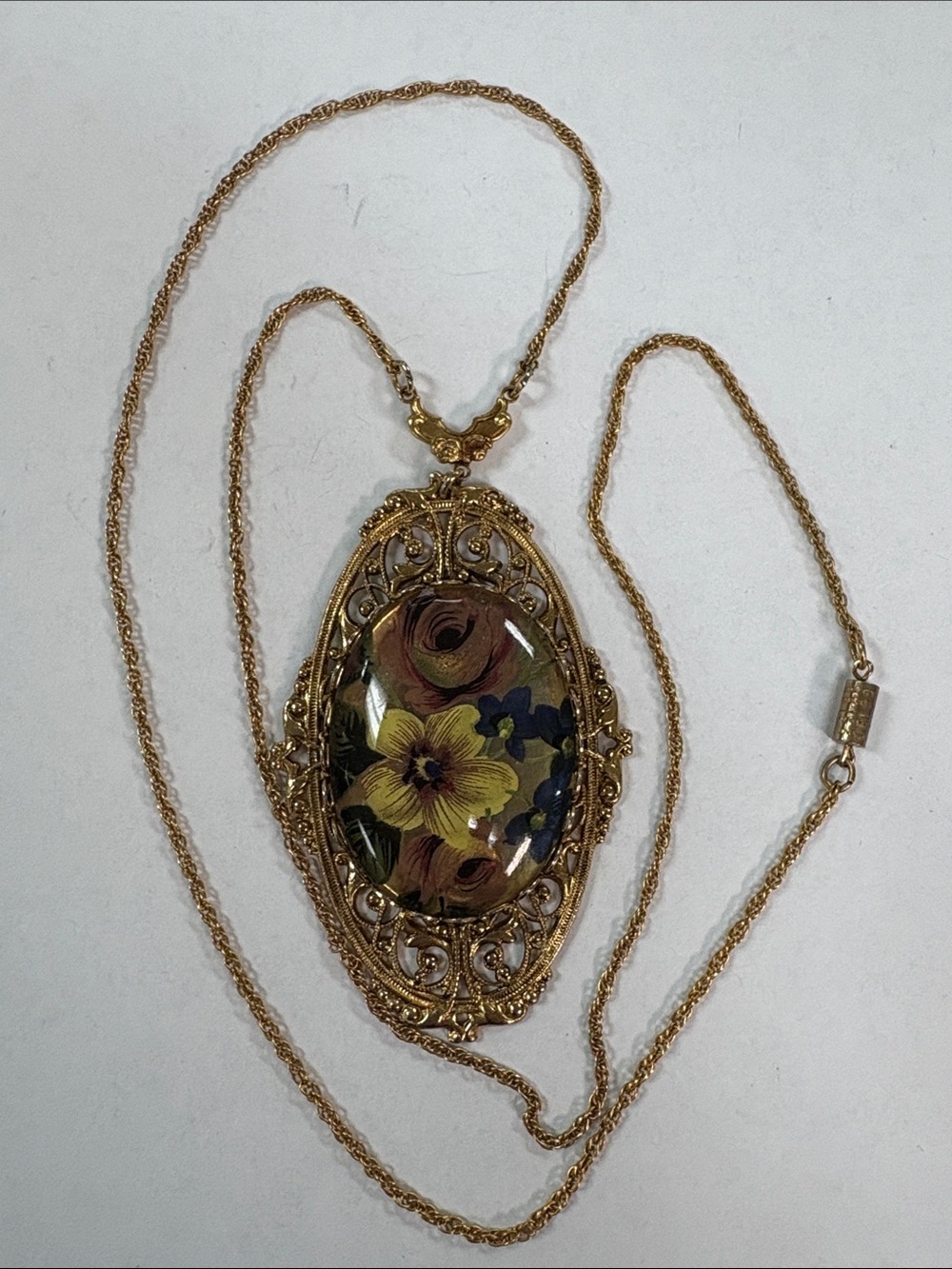 Floral pendant with gold tone necklace